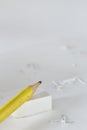 Yellow pencil White eraser and eraser leftovers white background