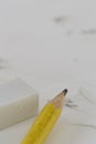 Yellow pencil White eraser and eraser leftovers white background