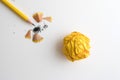 A Yellow pencil and yellow crumpled paper with shaving on white Royalty Free Stock Photo