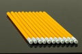 Yellow pencils arranged at a row on a black background. Back to Royalty Free Stock Photo