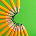 Yellow Pencils in a Circle on Green Background Royalty Free Stock Photo