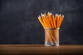 Yellow pencils in a pencil case against blackboard background. Back to school Royalty Free Stock Photo