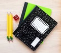4 pencils, a pencil sharpener and two notebooks with blank cover for customized message Royalty Free Stock Photo