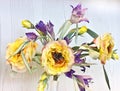 Yellow peonies and irises in a white vase. Artificial silk flowers in the interior Royalty Free Stock Photo