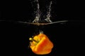 Yellow Pepper Falling Into The Water With A Splash