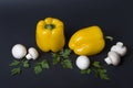 Yellow pepper with mushrooms and herbs on a dark background. Royalty Free Stock Photo