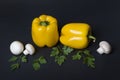 Yellow pepper with mushrooms and herbs on a dark background. Royalty Free Stock Photo