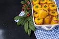 Yellow pepper stuffed with meat and rice in a pan for baking, on a black background and autumning branch for decoration. Free Royalty Free Stock Photo