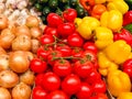 Yellow peppers, onions and tomatoes on a stand Royalty Free Stock Photo