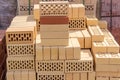 Yellow perforated bricks on pallet on an outdoor warehouse