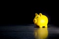Yellow pig piggy bank placed on desk black background