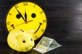 Yellow piggy bank and clock