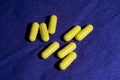 Yellow pills on blue background Royalty Free Stock Photo