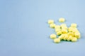 Yellow pills on a blue background. Royalty Free Stock Photo