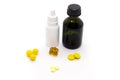 Yellow pills, bottle with brilliant green, nasal drops for the common cold on white background Royalty Free Stock Photo
