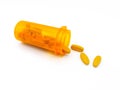 Yellow pills, drug or vitamin c spilling out of the orange medicine bottle  on white background. Royalty Free Stock Photo