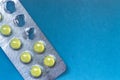 Yellow pills in the Pack launched on a blue background Royalty Free Stock Photo