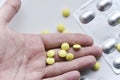 Yellow pills in the palm of your hand on a white background Royalty Free Stock Photo