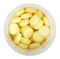 Yellow pills in round plastic bottle close up Royalty Free Stock Photo