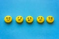 Yellow pills with smiles on a blue background. The concept of tr Royalty Free Stock Photo