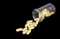 Yellow pills spilling out of a bottle Royalty Free Stock Photo