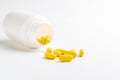 Yellow pills on white background