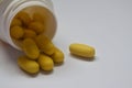 Yellow pills on a white background. Homeopathy, tranquilizers, antibiotics