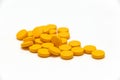 Big yellow round pills on white background Royalty Free Stock Photo