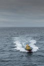 Yellow Pilot boat on Tasman Sea under rainy sky, Australia. Royalty Free Stock Photo