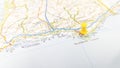 A yellow pin stuck in Faro Algarve on a map of Portugal