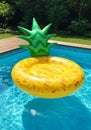 Yellow Pineapple Inflatable Pool Float in a Blue Pool Royalty Free Stock Photo