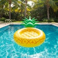 Yellow Pineapple Inflatable Pool Float in a Blue Swimming Pool Royalty Free Stock Photo