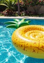 Yellow Pineapple Pool Float in a Blue Pool Royalty Free Stock Photo