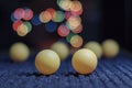 Yellow ping pong ball, with bokeh background, on black background Royalty Free Stock Photo