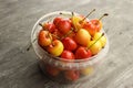 Yellow and pink cherries in a plastic container