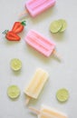 yellow and pink colorful fruity with lemon, strawberry  sliced  ice cream stick on white marble background Royalty Free Stock Photo