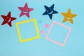 yellow and pink frame as copy space on blue background, colorful stars around Royalty Free Stock Photo