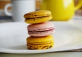 Yellow and pink mango-passionfruit, salted caramel, raspberry macaroons on white plate