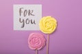 Yellow and pink Rose candy in pastel colors on a wooden stick with card