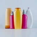 Colorful cosmetic bottles on a neutral background. Royalty Free Stock Photo