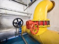 Yellow pipe with large diameter and red valve with stainless steel branch Royalty Free Stock Photo