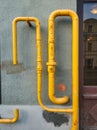 yellow pipes on the wall of a house
