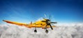 Yellow plane flying in the sky between clouds Royalty Free Stock Photo