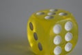 Yellow plastic arcylic d6 six sided die dice close up variable focus Royalty Free Stock Photo