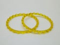 Yellow plastic bangles isolated on white background, beautiful fashion accessory Royalty Free Stock Photo