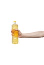 Yellow plastic bottle held in hand isolated on white. man holding vegetable oil Royalty Free Stock Photo