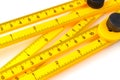 Yellow plastic carpenter ruler for measuring angles on white background close-up Royalty Free Stock Photo