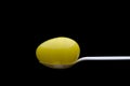 Yellow plastic Easter Egg on a white spoon Royalty Free Stock Photo