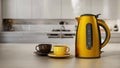 Yellow plastic electric kettle and coffee cups standing on kitchen counter. 3D illustration