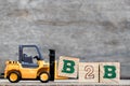 Yellow plastic forklift hold letter B to complete B2B